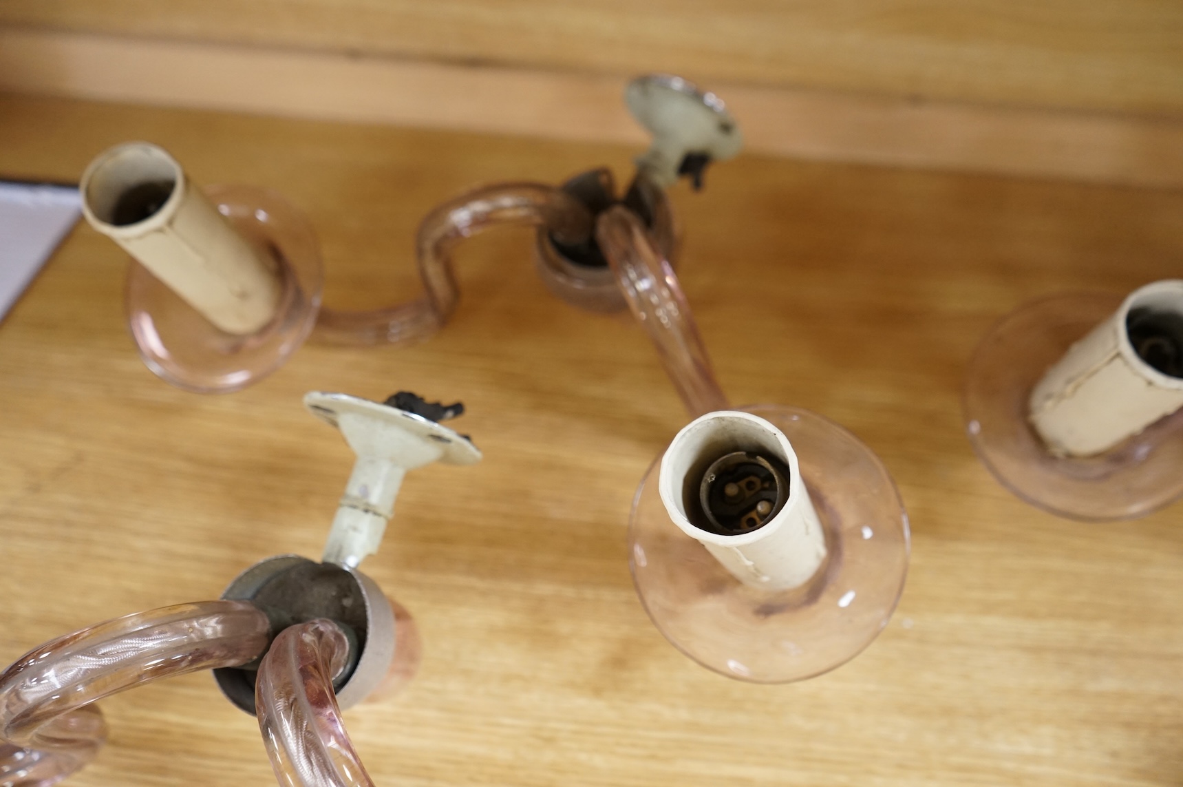 A set of four, two branch, pink glass wall lights, 25cm deep